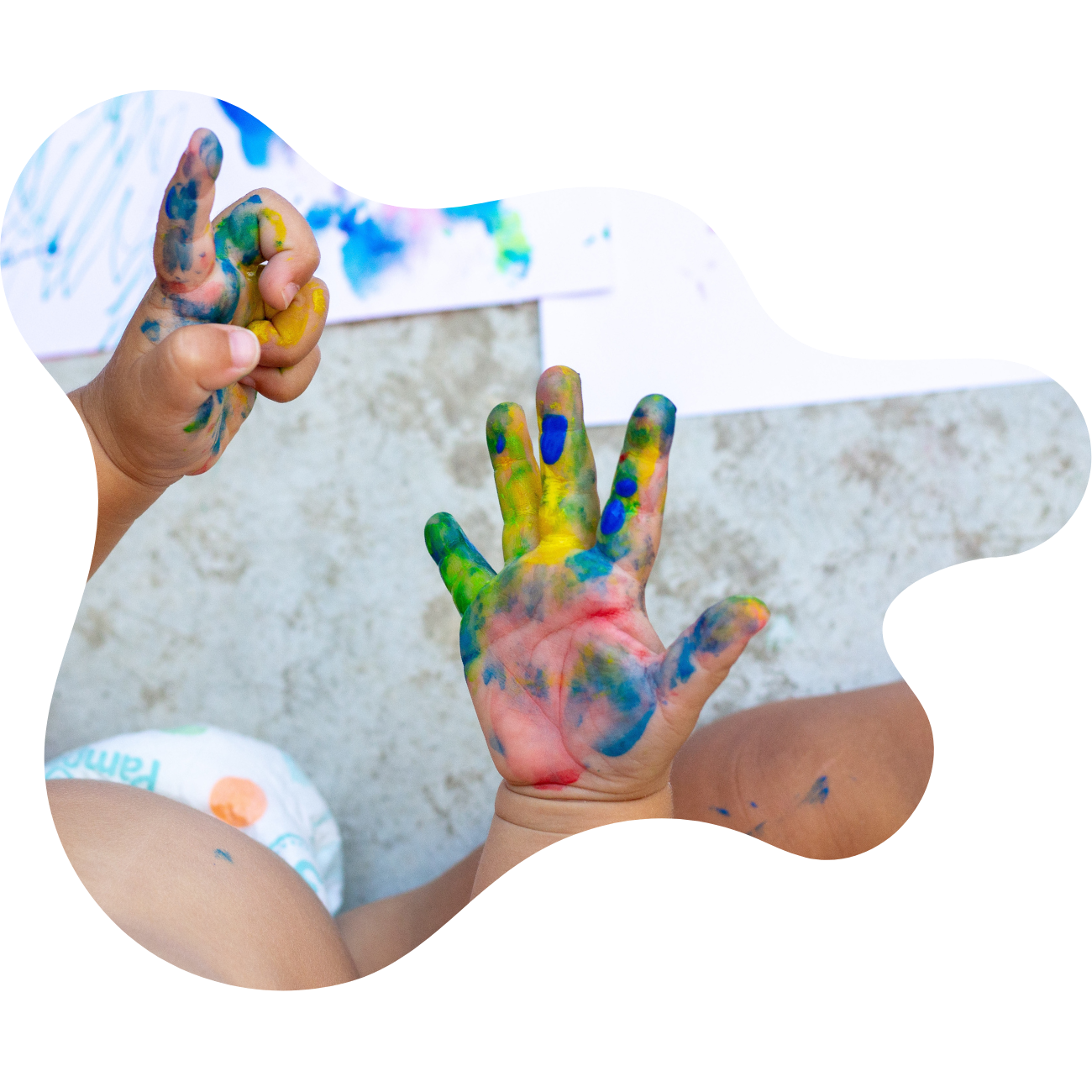 Image of a child with paint covered hands